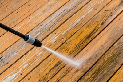 Power Washing Away Paint and Stain